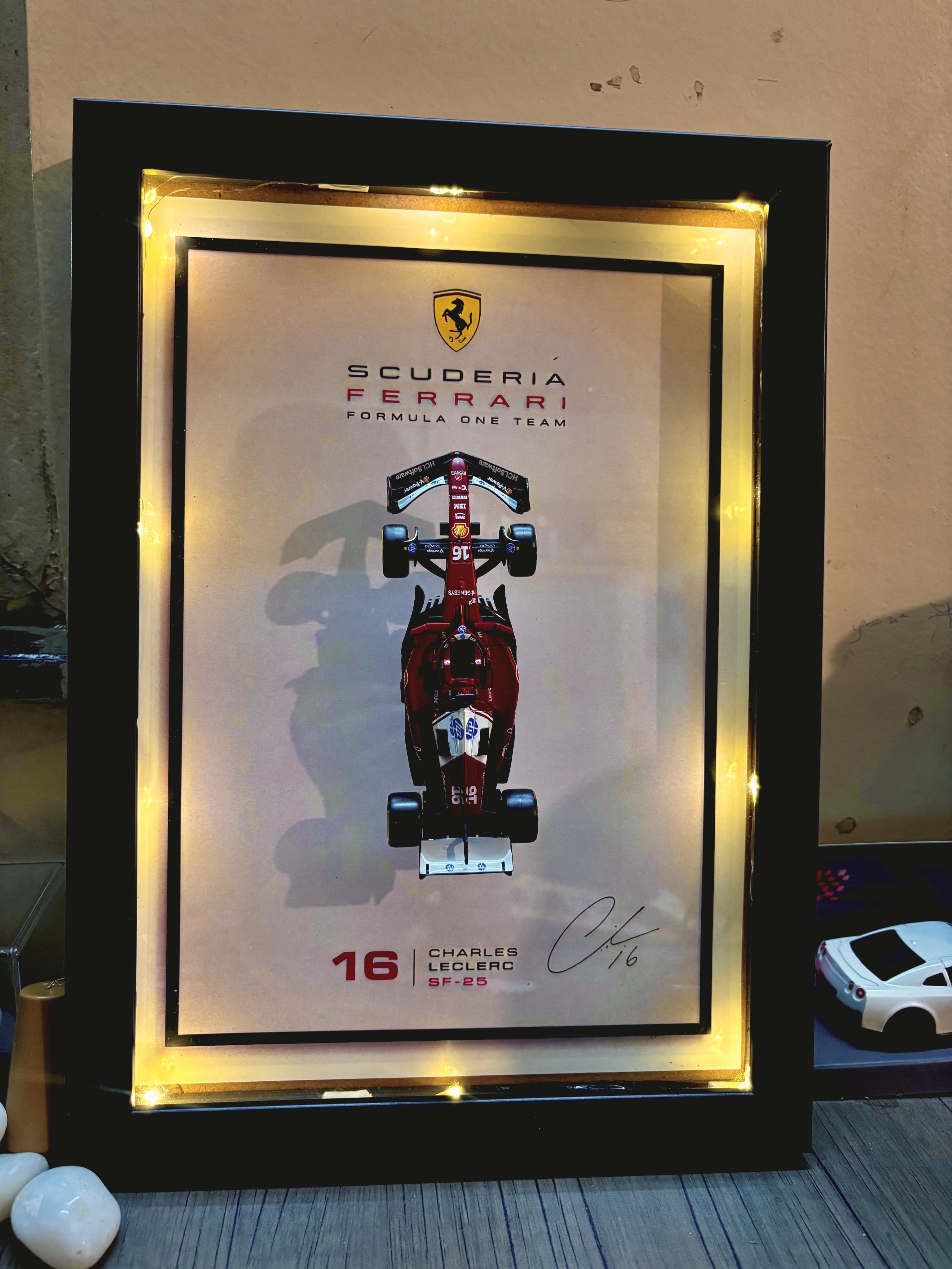 Bburago Ferrari Charles Leclerc #16 SF-25 model in LED display frame